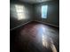 Simple bedroom with hardwood floors and two windows at 3046 Gordon Cir, Atlanta, GA 30354