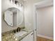 Bathroom with granite countertop, modern vanity, and octagon mirror at 1431 Brandy Shoals Se Ct, Conyers, GA 30013