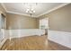 Dining room with hardwood floors, wainscoting, and kitchen view at 1431 Brandy Shoals Se Ct, Conyers, GA 30013