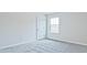 Bright bedroom with gray carpet and a window at 4192 Waratah Way, Mableton, GA 30126