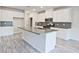 Modern kitchen with white cabinets, large island, and gray countertops at 4192 Waratah Way, Mableton, GA 30126