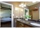 Double vanity bathroom with granite countertops, and a view into a bedroom at 503 Mary Margaret Walk, Loganville, GA 30052