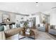 Open concept living room features stylish furniture and a view into the kitchen at 386 Village Ln, Fairburn, GA 30213