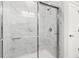 Large walk-in shower with marble tile and modern fixtures at 386 Village Ln, Fairburn, GA 30213