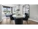 Elegant dining area with round table and four chairs, adjacent to living area at 386 Village Ln, Fairburn, GA 30213