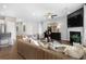 Open living room with fireplace, built-in shelving, and large windows at 386 Village Ln, Fairburn, GA 30213