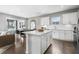 Open kitchen with white cabinets, island, and stainless steel appliances at 386 Village Ln, Fairburn, GA 30213