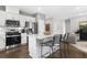 Bright kitchen boasts stainless steel appliances and an island with seating at 386 Village Ln, Fairburn, GA 30213