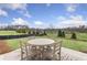 Peaceful backyard patio with seating area and view of open space at 386 Village Ln, Fairburn, GA 30213