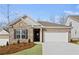 Brick home with a two-car garage and manicured landscaping at 386 Village Ln, Fairburn, GA 30213