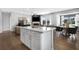 Open concept kitchen with white cabinets and a large island at 386 Village Ln, Fairburn, GA 30213