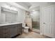 Basement bathroom with walk-in shower, gray vanity, and tile flooring at 1428 Sparkling Cove Dr, Buford, GA 30518