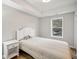 Spacious basement bedroom with a queen-size bed and large window at 1428 Sparkling Cove Dr, Buford, GA 30518