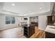 Finished basement features a kitchenette with an island and hardwood floors at 1428 Sparkling Cove Dr, Buford, GA 30518