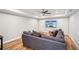 Finished basement with sectional sofa, large TV, and hardwood floors at 1428 Sparkling Cove Dr, Buford, GA 30518