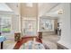 Two-story foyer with hardwood floors, stone columns, and large windows at 1428 Sparkling Cove Dr, Buford, GA 30518
