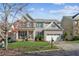 Brick two-story house with a three-car garage and landscaped lawn at 1428 Sparkling Cove Dr, Buford, GA 30518