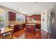 Kitchen with island, granite countertops, and dark wood cabinets at 1428 Sparkling Cove Dr, Buford, GA 30518