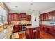 Kitchen with granite countertops, dark wood cabinets, and stainless steel appliances at 1428 Sparkling Cove Dr, Buford, GA 30518