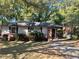 Brick ranch house with a well-maintained lawn and mature trees at 1885 Broad Ave, East Point, GA 30344