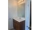 Simple bathroom with a brown vanity and a large mirror at 2118 Water Mill Ct, Buford, GA 30519