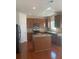Spacious kitchen with hardwood floors, an island, and wood cabinets at 2118 Water Mill Ct, Buford, GA 30519