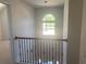 Upstairs hall with a stunning arched window and chandelier at 2118 Water Mill Ct, Buford, GA 30519
