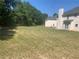 Large backyard with a mostly grassy area and partial view of the house at 2118 Water Mill Ct, Buford, GA 30519