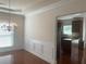 Formal dining room with hardwood floors and chandelier, open to kitchen at 2118 Water Mill Ct, Buford, GA 30519