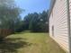 Spacious backyard with a grassy area, providing ample outdoor space at 2118 Water Mill Ct, Buford, GA 30519