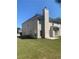 Two-story house with light beige vinyl siding, a large backyard, and a chimney at 2118 Water Mill Ct, Buford, GA 30519