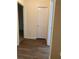 Hallway with wood-look flooring and doors leading to various rooms at 6950 Oakhill Se Cir, Austell, GA 30168