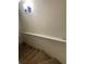 Carpeted stairway with white railing and a wall sconce at 6950 Oakhill Se Cir, Austell, GA 30168