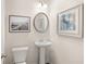 Modern powder room with pedestal sink, toilet, and framed art at 224 Epping St # 7, Stockbridge, GA 30281