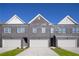 Three-unit townhome building with gray brick exterior and attached garages at 224 Epping St # 7, Stockbridge, GA 30281