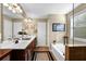 Elegant bathroom featuring double sinks, a soaking tub, and a walk-in shower at 21 Belmore Manor Dr, Suwanee, GA 30024