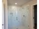 Walk-in shower with marble tile and glass door at 452 Eagles Nest Cir, Auburn, GA 30011