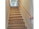 Unfinished staircase with oak handrail and simple design at 452 Eagles Nest Cir, Auburn, GA 30011