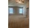 Large bedroom with neutral carpet, high ceiling and two windows at 11967 Brightside Pkwy, Hampton, GA 30228