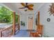 Relaxing front porch with a ceiling fan and rocking chair at 1485 Ryan Sw St, Atlanta, GA 30310