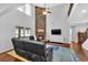 Living room with a cozy fireplace, hardwood floors, and large windows at 313 Hill Top Overlook, Canton, GA 30114