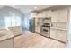 Spacious kitchen with white cabinets, granite counters, and stainless steel appliances at 340 Bay Grove Rd, Loganville, GA 30052