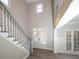Two-story foyer with staircase, hardwood floors, and natural light at 340 Bay Grove Rd, Loganville, GA 30052