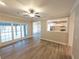 Gathering room with hardwood floors, ceiling fan, and view of backyard at 340 Bay Grove Rd, Loganville, GA 30052