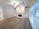 Living room features hardwood floors, a fireplace, and built-in shelving at 340 Bay Grove Rd, Loganville, GA 30052