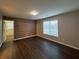 Bedroom with wood-look flooring and accent wall at 340 Bay Grove Rd, Loganville, GA 30052