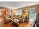 Living room with hardwood floors, sectional sofa, and fireplace, plus view of backyard at 1778 Campbellton Sw Rd, Atlanta, GA 30311