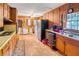 Retro kitchen features wood cabinets, built-in appliances, and vinyl flooring at 1778 Campbellton Sw Rd, Atlanta, GA 30311