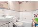 Small bathroom with white tile and a bathtub at 1778 Campbellton Sw Rd, Atlanta, GA 30311
