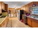 Retro kitchen features wood cabinets, built-in appliances, and vinyl flooring at 1778 Campbellton Sw Rd, Atlanta, GA 30311